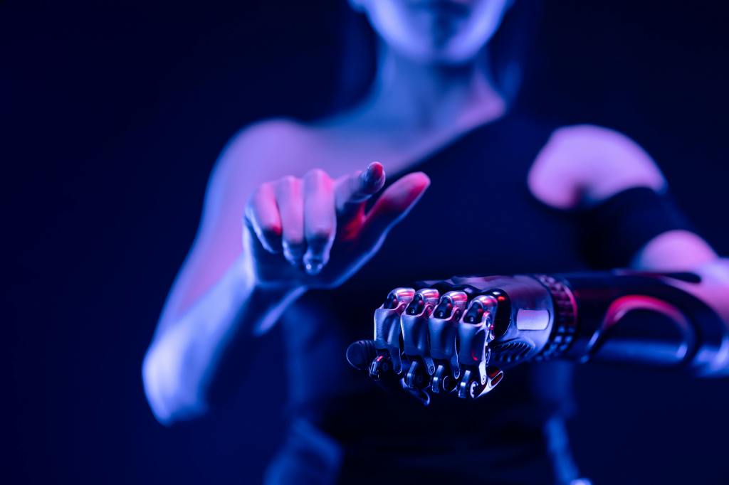 Woman tapping a finger against her cybernetic hand