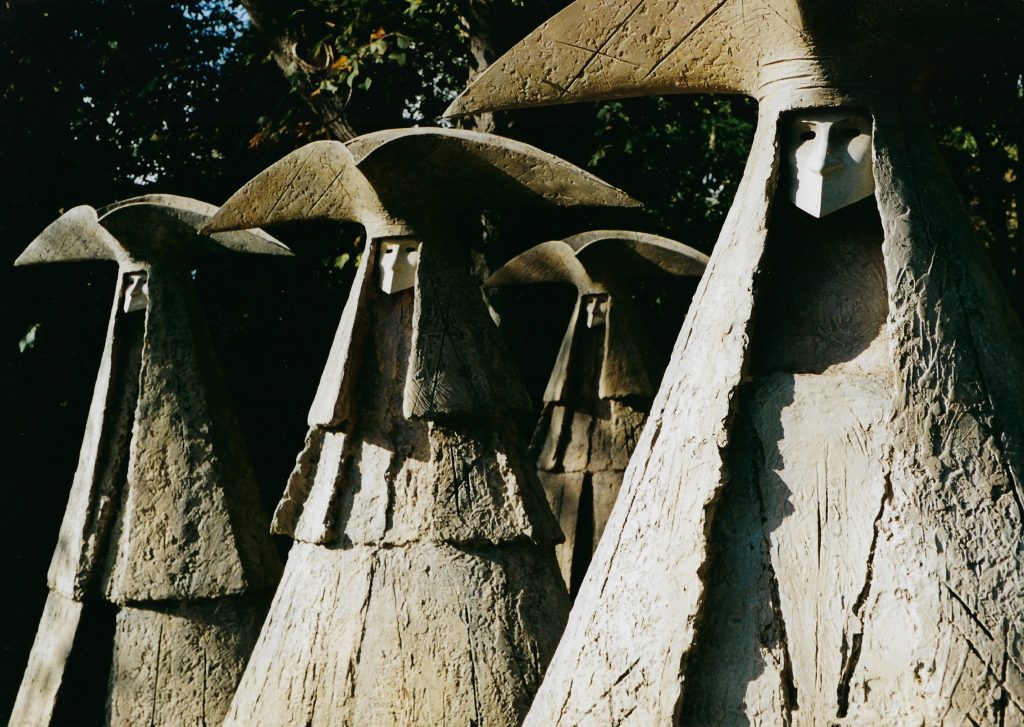Eerie statues in wide-brimmed custumes