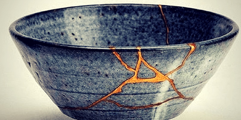 A blue pottery bowl repaired with gold via kintsugi 